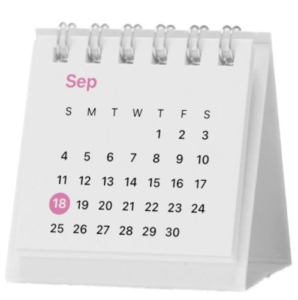 A small, desk calendar displaying the month of September with the date 18 highlighted